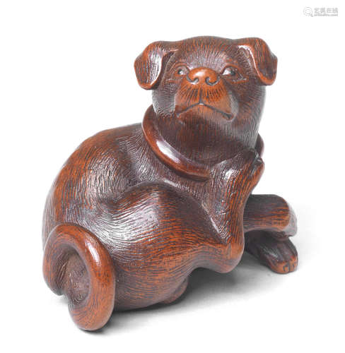 A boxwood netsuke of a dog 19th century