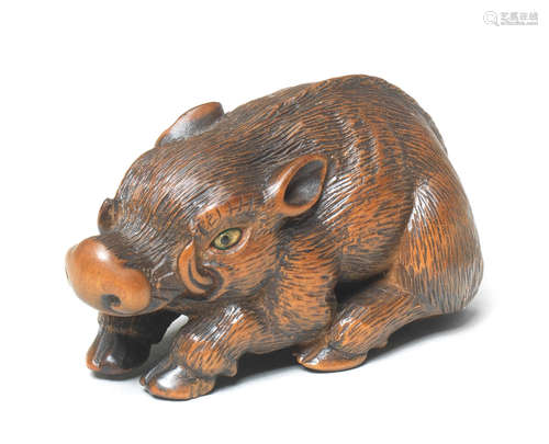 A wood netsuke of a recumbent boar By Tanaka Minko (1735-1816), Tsu, Ise Province, late 18th/early 19th century