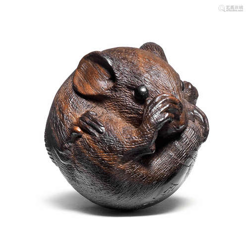 A kurogaki (black persimmon) wood netsuke of a coiled rat By Masanao, Ise, 19th century