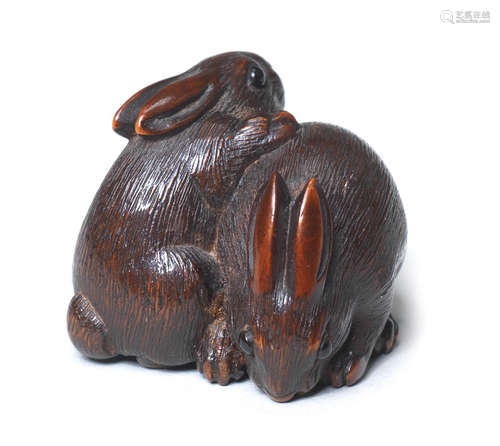 A wood netsuke of two rabbits By Kokei, Kuwana, Ise Province, 19th century