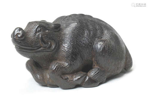 A wood netsuke of a recumbent boar By Kokei, Kuwana, Ise Province, late 18th century