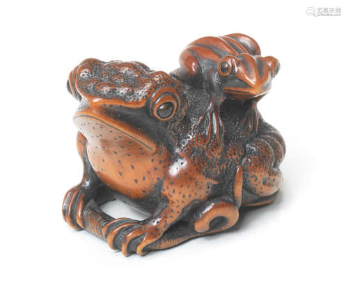 A wood netsuke of a toad and young By Miwa, Edo, early 19th century