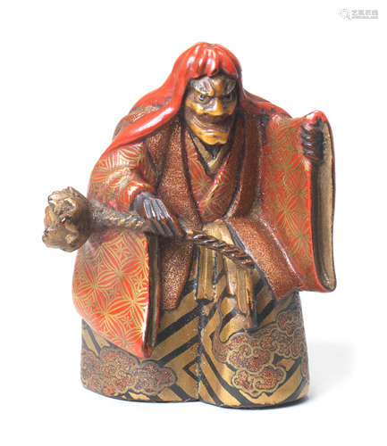 A lacquered wood netsuke of a Noh actor By Issai, late 19th century