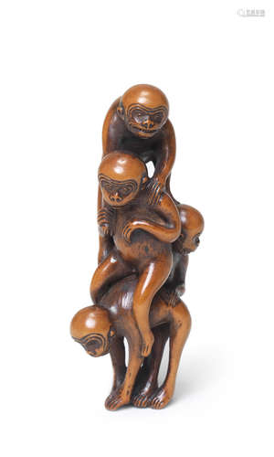 A wood netsuke of a pyramid of monkeys 18th century