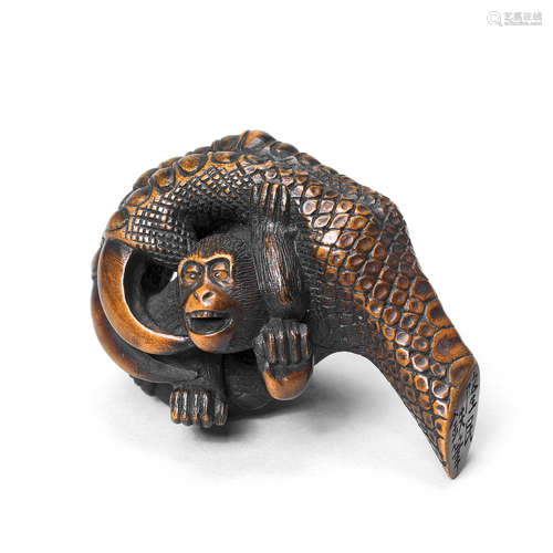 A wood netsuke of a monkey in an eagle's claw By Ryumin, 19th century