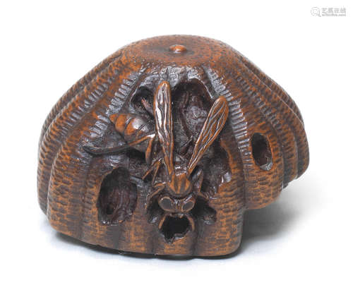 A wood netsuke of a wasp and nest Early 19th century