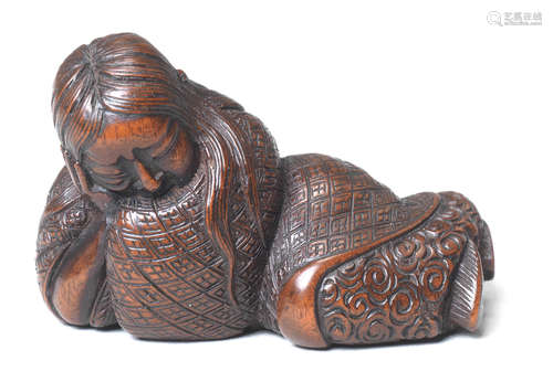 A wood netsuke of a sleeping Shojo By Ikkan (1817-1893), Nagoya, 19th century