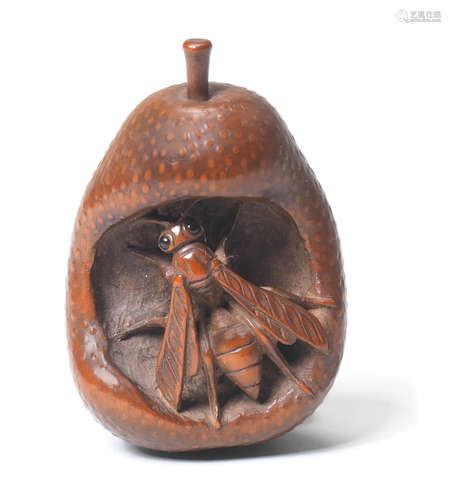 A wood netsuke of a wasp in a rotting pear By Gekko, late 18th/early 19th century