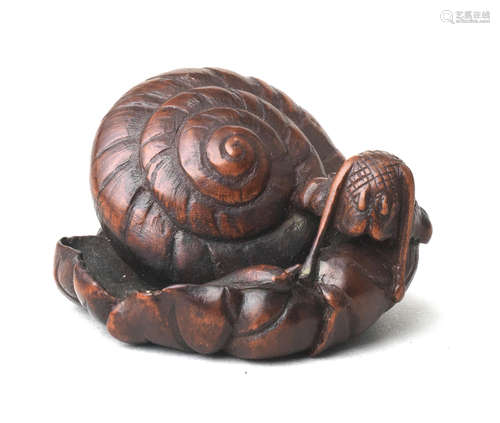 A wood netsuke of a snail By Sari, Iwashiro Province, early 19th century