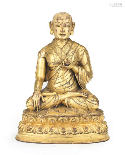 A gilt-bronze inscribed figure of a Buddhist preceptor Tibet, circa 16th century