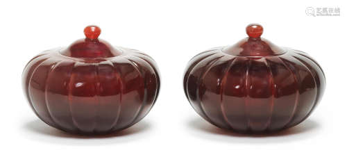 A pair of Imperial ruby-red melon-shaped glass jars and covers Qianlong four-character marks and of the period