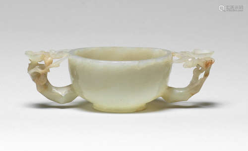 A pale green jade two-handled 'prunus' cup Ming Dynasty