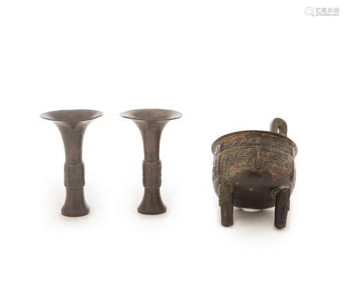 A pair of archaistic beaker vases, gu, and an archaistic incense burner, ding The ding