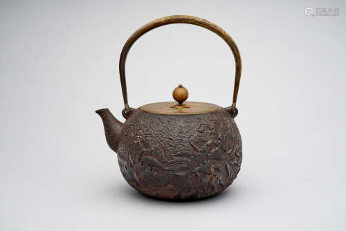 An 'peony' cast iron kettle  Four character impressed studio mark