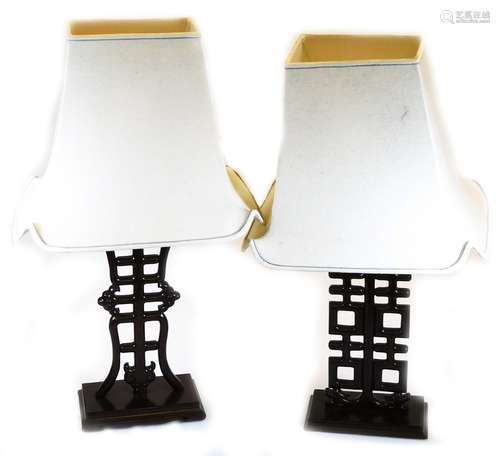 A pair of Chinese hardwood table lamps, each of pierced form on rectangular bases, with modern