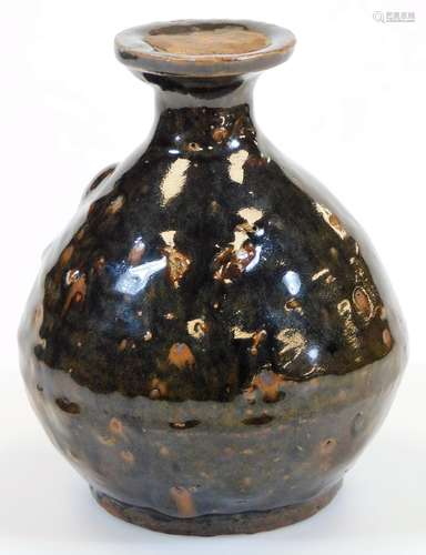 A West Country type glazed pottery bottle, of globular form, with a fixed seal to the neck, slip