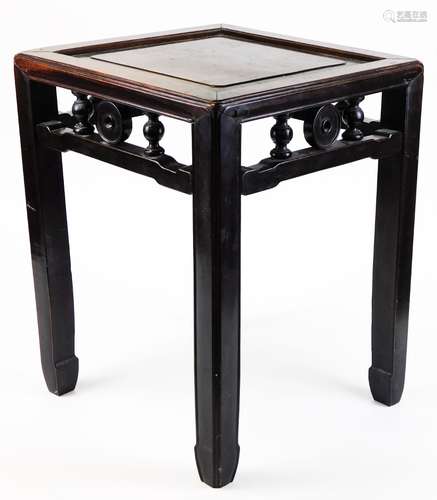 A Chinese hardwood plant stand, of square form on camfered legs, with a carved frieze, 50cm high,