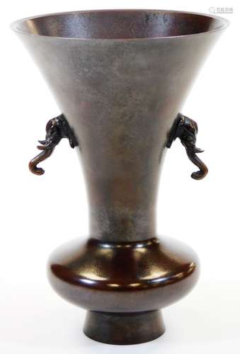 A Japanese bronze ikabana vase, with everted rim and elephant head handles, mottled reddish