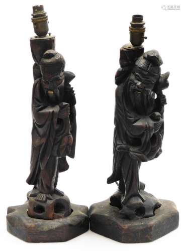 A pair of late 19th/early 20thC oriental carved hardwood lamp bases, each decorated in the form of