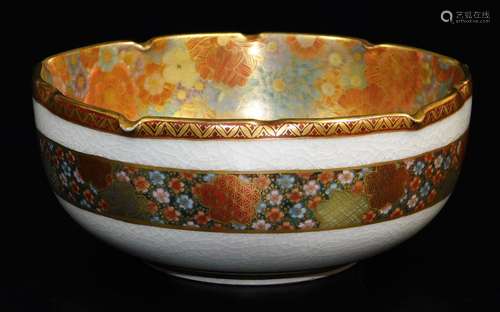 A Japanese Satsuma bowl, decorated with a dense mass of gilt and coloured flower heads to the