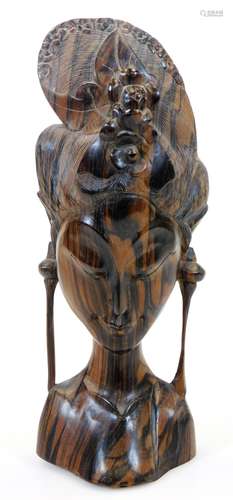 A heavily carved African tribal tiger wood head, with elaborate floral headdress, unsigned, 33cm