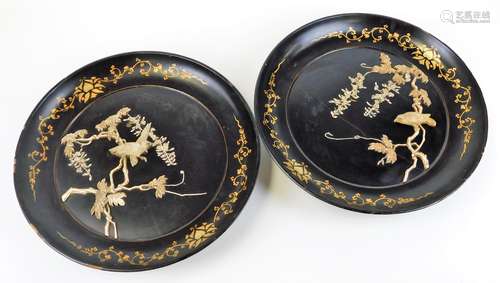 A pair of early 20thC Japanese Meiji period black lacquered circular wooden wall plaques, each