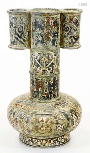 A Chinese bronze arrow vase, decorated in Shang style inlaid in silver with archaic designs, masks