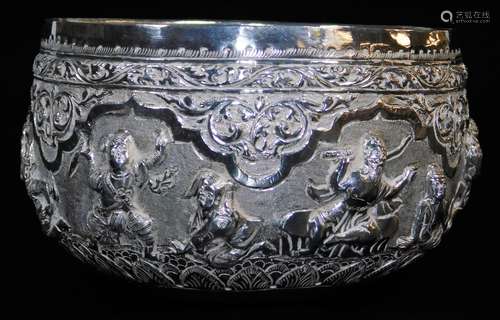 An early 20thC Indian ceremonial bowl, heavily repousse decorated with figures scrolls and