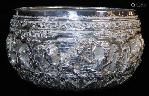 An early 20thC Indian ceremonial bowl, heavily repousse decorated with figures scrolls and