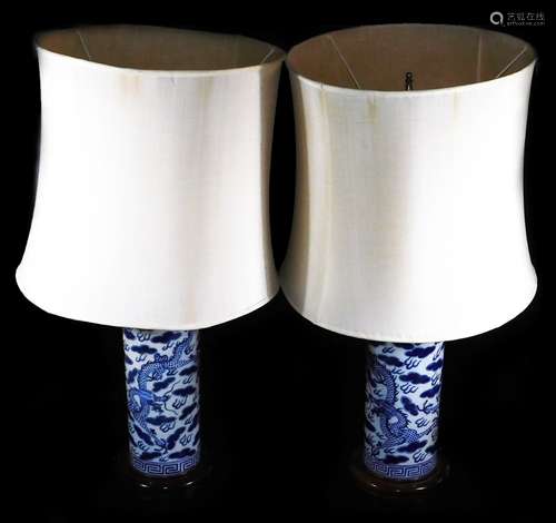 A pair of Chinese porcelain table lamps, of cylindrical form decorated with clouds and dragons on