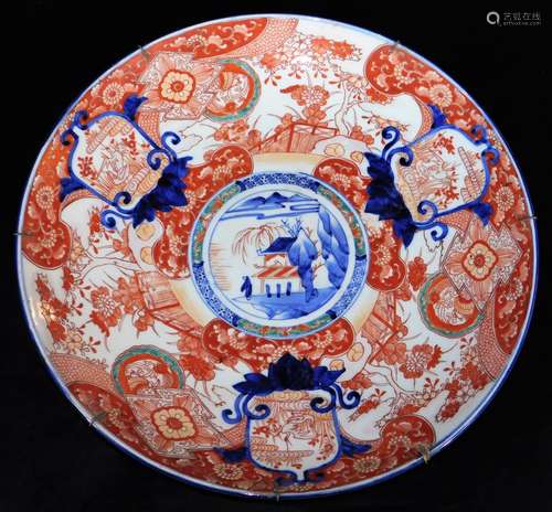 A Japanese porcelain Imari charger, decorated in typical red, orange, green and underglaze blue