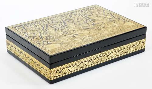 A 20thC Thai lacquered box, with gilt highlight, decorated with figures of musicians, 31cm wide.