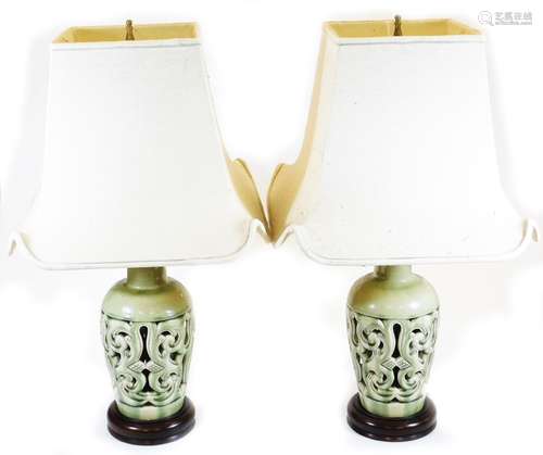 A pair of 20thC Chinese celadon table lamps, each pierced shouldered form, with trumpet stems,