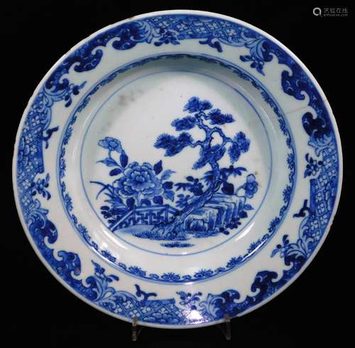 An 18thC blue and white Chinese export porcelain soup bowl, with central panel of trees and