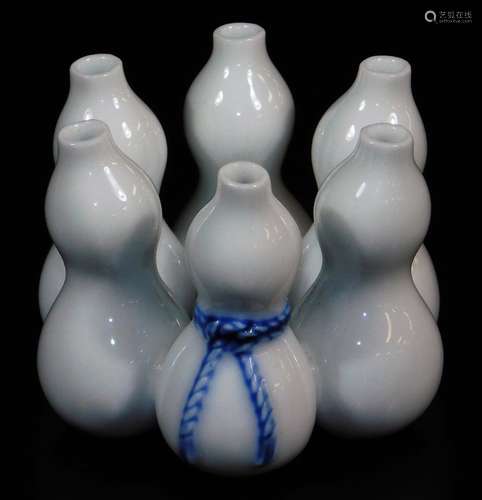 A Japanese Hirado porcelain lid rest, for tea ceremony formed as six double gourds, one gourd with