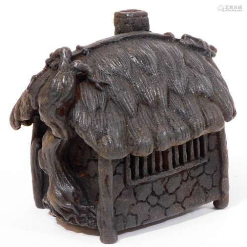 A Japanese iron koro and cover, shaped as a thatched hut, with vine growing up one side, Taisho