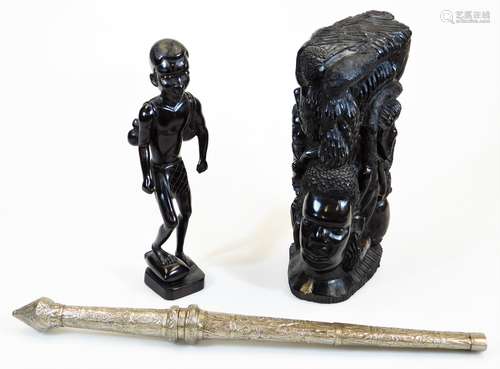 A heavily carved African tribal style figure, with foot raised on a canted base, unmarked, 32cm