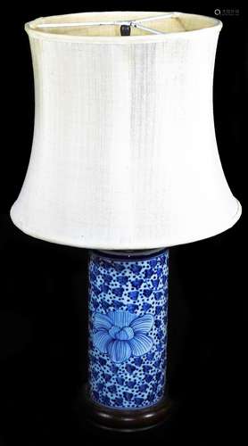 A Chinese porcelain table lamp, of cylindrical form with wooden mounts decorated with flower heads