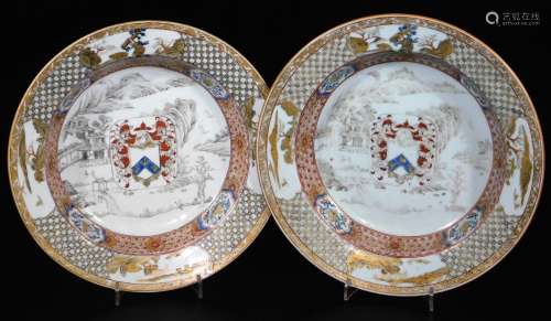 A pair of 18thC Chinese export armorial soup bowls, decorated with central amorials on a landscape