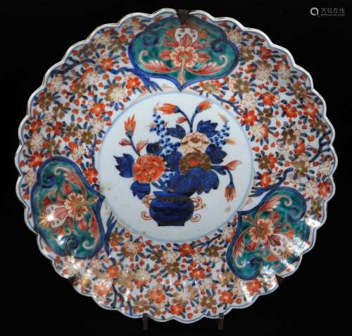 A Japanese Imari charger, of shaped floral form, centred with a vase of flowers, with an outer