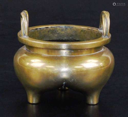 A Chinese bronze tripod censer, with bulbous body and twisted loop handles, six character Xuande