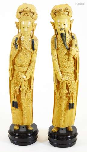 A pair of faux ivory figures, in flowing robes on fixed bases, 45cm high. (2)