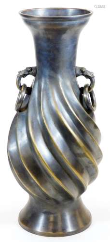 A large Japanese bronze vase, the body with relief spiral twist and loose ring animal head