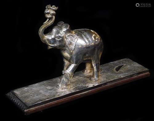 An early 20thC ceremonial figure group of an elephant being attacked by a wild beast, with trunk