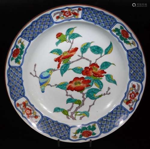 A 20thC Japanese dish, of shaped circular form decorated with flowering shrubs and bird with an