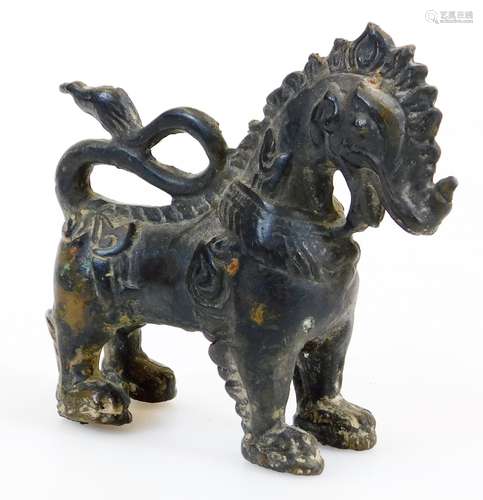 A Chinese metal figure of a standing beast, 10cm high.