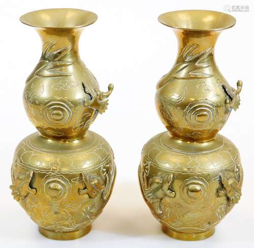 A pair of 20thC polished brass Chinese double gourd vases, raised with various scenes, animals,