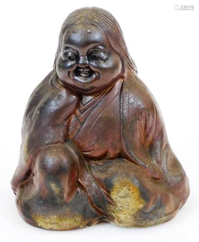 A Japanese Bizen figure of Okame, smiling blissfully as she pleasures herself, Meiji period, 15.