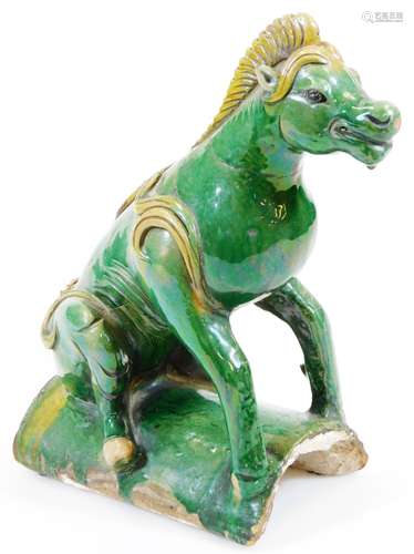 A Chinese Ming style pottery roof tile figure of a wild animal, in green and yellow glazes on an