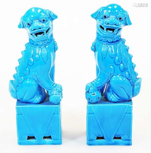 A pair of late 20thC Chinese dog of fo ornaments, in turquoise glaze on rectangular bases, each with